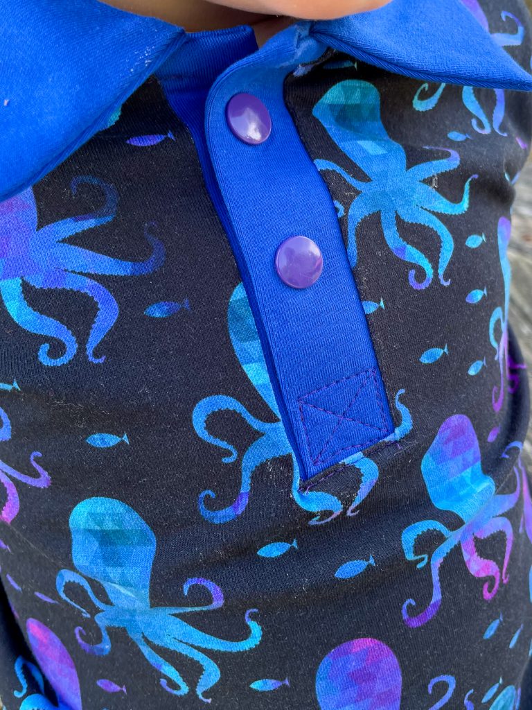 close up photo of a dark blue polo shirt with octopus print
