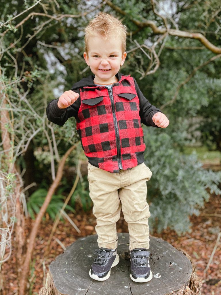 grinning photo of a kid wearing Dutchie jacket with hands in pocket