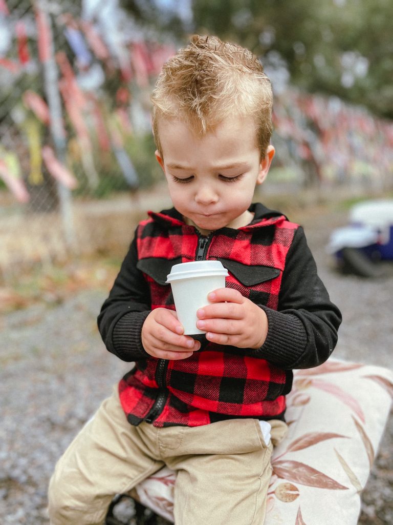 photo of a kid looking at his drink